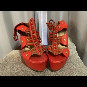 Check out these Carlos Santana gold and coral wedge shoes.
